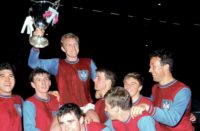 Bobby Moore shows off the trophy as West Ham celebrate